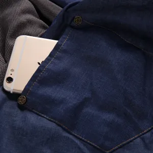 Denim pet bag pocket detail, breathable mesh lining, durable metal button hardware close-up.