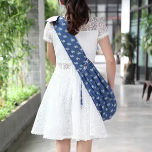 Breathable denim pet sling bag with palm tree print, perfect for carrying small dogs outdoors.