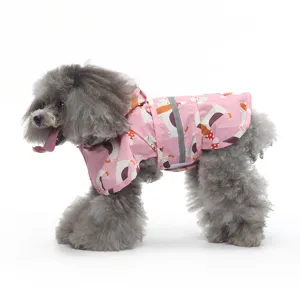Pink dog raincoat detail showing hooded design and reflective strip for rainy walks.
