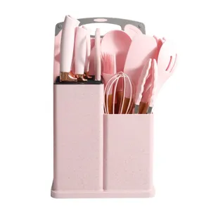 Pink silicone kitchen utensil set with holder, non-stick spatula and spoon cooking tools.