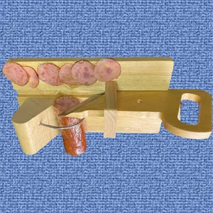 Hand-operated oak sausage slicer with stainless steel blade showing sliced ham on the side