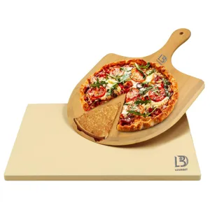 Pizza stone and wooden peel detail shot, heat resistant baking board for homemade pizza and bread.