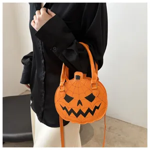 Close-up view of a stylish pumpkin-shaped orange handbag paired with a black silk shirt