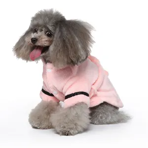 Detailed side view of a cozy pink plush pet bathrobe worn by a small gray poodle