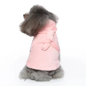 Close-up back view of a soft pink hooded pet bathrobe shown on a fluffy small dog