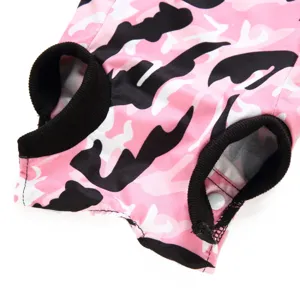 Close-up detail of pink camouflage pet recovery suit, soft breathable fabric with black ribbed trim.
