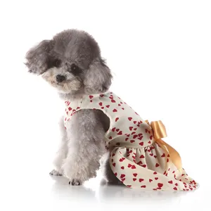 Detailed view of pet dog summer dress with red hearts and cute golden bow, lightweight fabric.