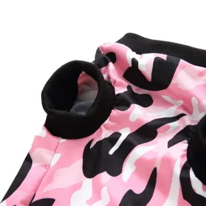 Close-up of pet recovery suit, pink camo pattern with black ribbed collar details.