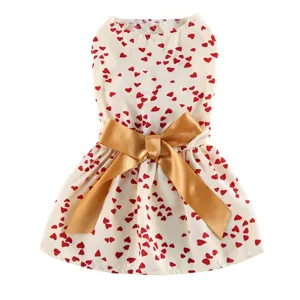 Cute pet dog dress with red hearts and a gold satin bow, perfect for summer daily wear.