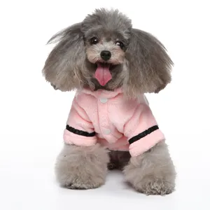 Detailed view of a small grey poodle wearing a soft pink plush pet bathrobe accessory.