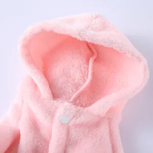 Detailed close-up of a soft pink plush pet bathrobe showing hood and white button texture