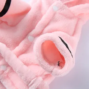 Close-up of soft pink plush pet bathrobe showing white snap buttons and black sleeve trim