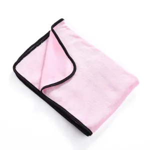 Detailed view of a soft pink fleece pet blanket with black binding, perfect for cats and dogs.