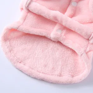 Close-up of pink soft fleece pet bathrobe showing plush texture and white snap button.