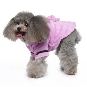 Detail of soft pink plush dog bathrobe with a cozy hood shown on a cute gray poodle