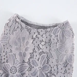 Close-up of grey floral lace pet dress fabric texture, delicate embroidery design.