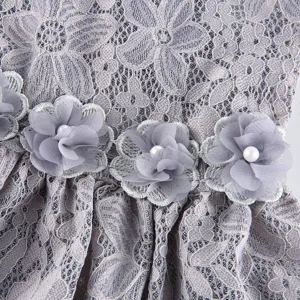Close-up detail of grey floral lace pet dress featuring elegant chiffon flowers and pearl decor.