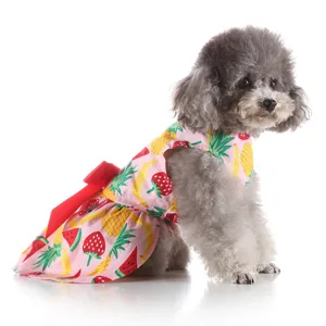 Detail view of cute summer fruit print dog dress with red bow, comfortable pet apparel.
