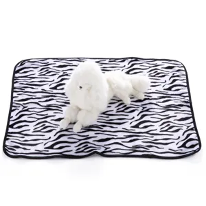 Detailed view of soft zebra patterned fleece pet blanket with a cute plush dog toy display prop.