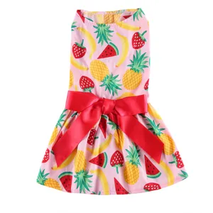Cute fruit print pet summer dress detail, pink dog clothes with big red bow decoration.