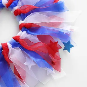 Close-up detail of patriotic red white and blue pet ribbon collar with bell and stars