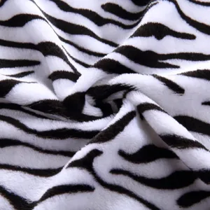 Close-up detail of soft zebra print fleece fabric, showcasing plush texture and cozy feel.