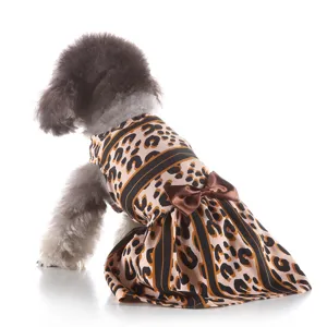 Cute leopard print dog dress with a brown satin bow, perfect summer outfit for small pets.