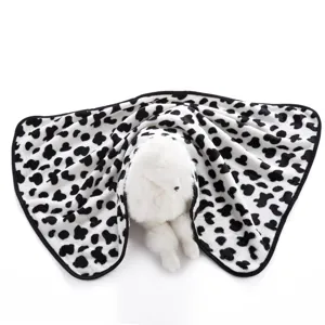 Soft pet blanket detail closeup, black and white printed fleece fabric, cozy double-sided design.