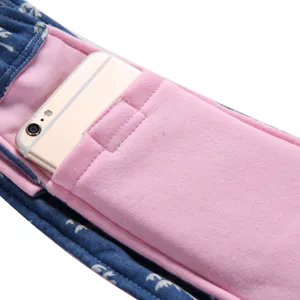 Pet carrier bag detail shot showing convenient phone pocket and breathable blue floral fabric.