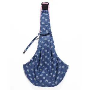 Breathable denim pattern pet sling carrier detail showing palm tree print and pink lining fabric.