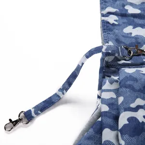 Close-up detail of the durable blue camo fabric pet bag strap with metal lobster clasps.