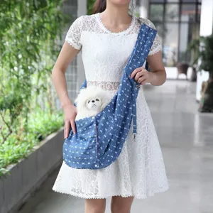 Breathable denim pet sling bag, portable cross-body dog carrier for outdoor travel daily.