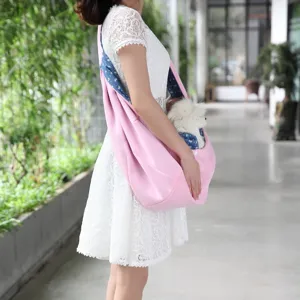 Breathable pink pet sling bag with blue patterned interior for small dogs and cats outdoor.