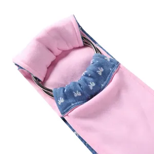 Detailed close-up of pink and blue pet sling carrier with metal rings and bow print fabric.