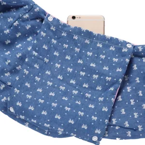 Detailed view of blue pet sling bag with cute bow print pattern and front pocket storage.