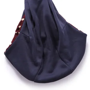 Pet sling carrier bag detail view showing soft blue fabric and red polka dot lining.