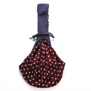 Breathable pet sling bag detail, blue strap and maroon polka dot pouch, portable outdoor dog carrier.