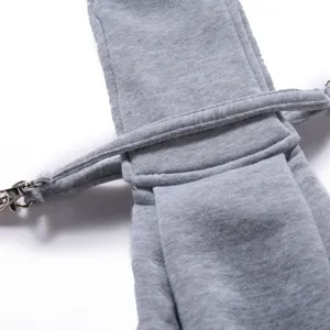 Close-up detail of gray pet sling bag adjustable strap and metal hardware for safe outdoor travel