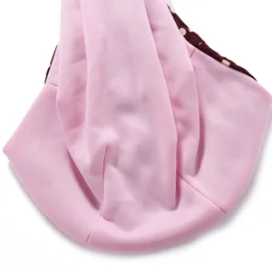 Detail view of the pink breathable pet sling bag, showing soft fabric and stylish polka dot lining.