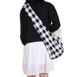 Dog sling bag detail shot showing breathable black and white checkered fabric and comfortable fit.