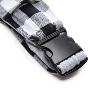 Detailed view of breathable pet carrier bag strap with black and white buffalo plaid.