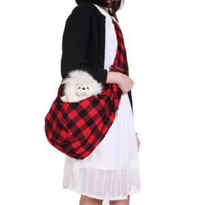 Detailed view of the red and black plaid pet sling carrier, breathable design for small dogs.