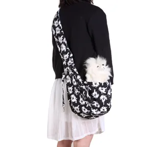 Detailed view of black and white printed pet sling bag worn by model, breathable outdoor carrier.