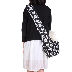 Breathable single shoulder pet sling bag with black and white dog pattern for outdoor travel.