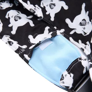 Pet bag detail view featuring cute dog print fabric, breathable blue lining, and adjustable strap.