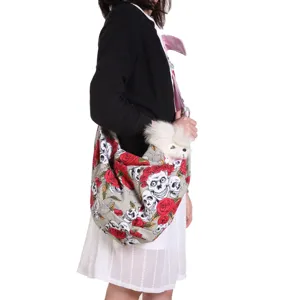 Breathable single shoulder pet sling bag featuring skull and rose print for small dogs.