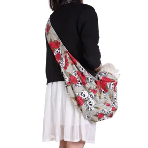 Close-up detail of pet sling bag showing skull rose pattern, strap and comfortable breathable design.