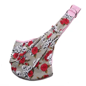 Close-up view of pet sling bag with gothic skull rose print and adjustable metal ring strap.