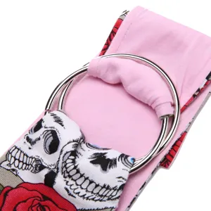 Detailed view of the pet sling bag strap featuring a unique skull and rose print with metal rings.