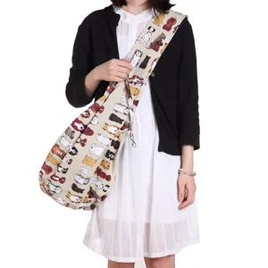 Canvas pet carrier shoulder bag, cute dog print sling crossbody bag for outdoor travel.